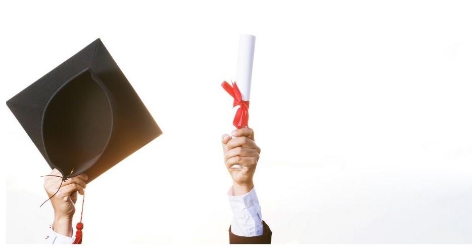 A diploma and graduation cap
