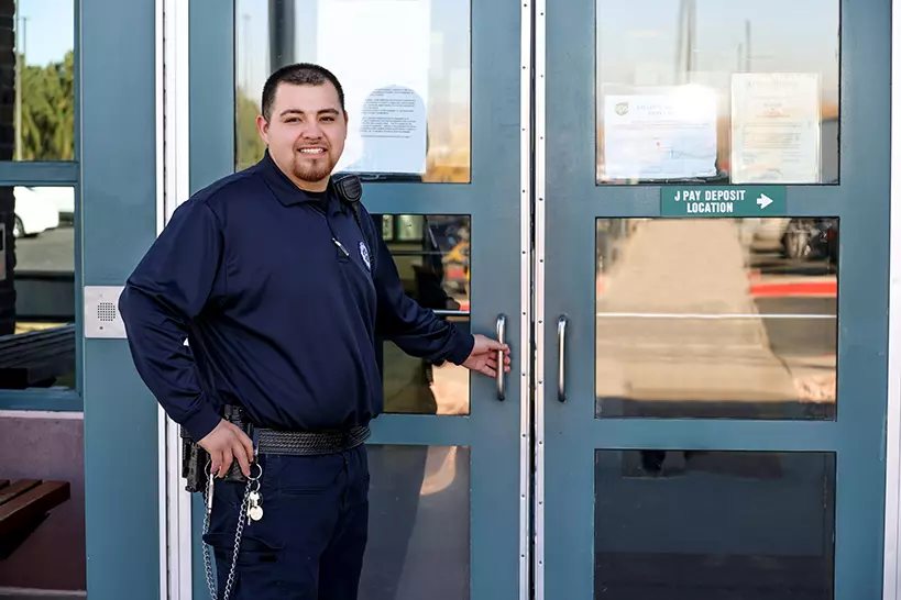 Correctional Officer standing in front of doors